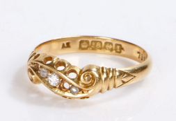 18 carat gold diamond set ring, with three diamonds crossing over the head with scroll ends, 2.9