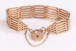 9 carat gold six bar gate bracelet, with with padlock clasp and security chain, 24.9 grams