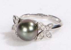 18 carat white gold pearl and diamond set ring, the central opal flanked by diamond set petals,