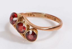 9 carat gold and garnet set ring, with three garnets crossing over the shank, 2 grams, ring size Q