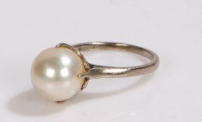 14 carat white gold Mikimoto pearl set ring, the pearl held by four claws, ring size F