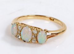 18 carat gold opal and diamond set ring, with three opals and six diamonds to the head, 2.9 grams,