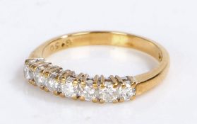 18 carat gold diamond set ring, with a row of seven round cut diamonds at 0.50 carats in total, 2.