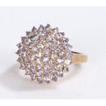 9 carat gold ring, the head set with a cluster of violet stones, 4.2 grams, ring size K