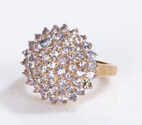 9 carat gold ring, the head set with a cluster of violet stones, 4.2 grams, ring size K