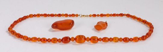 Amber necklace, with a graduated row of beads interspersed with small beads, the largest bead 17mm