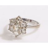 18 carat white gold diamond set ring, the ring in the form of a flower head set with seven diamonds,