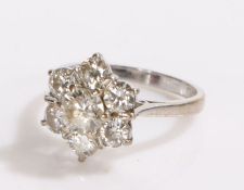 18 carat white gold diamond set ring, the ring in the form of a flower head set with seven diamonds,