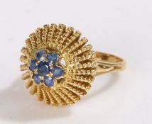 18 carat gold sapphire set ring, the head set with seven sapphires and a wide head, 6.2 grams,