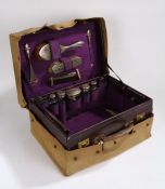 George V leather travelling vanity case, the purple leather case with embossed gilt initials M.E.