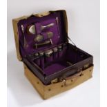 George V leather travelling vanity case, the purple leather case with embossed gilt initials M.E.