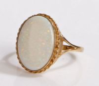 9 carat gold opal set ring, the large cabochon cut opal set to a rope twist edge, 3.6 grams, ring
