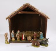 Mid 20th Century nativity scene, the stable with straw roof, containing figures depicitng Jesus,