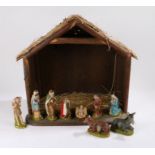 Mid 20th Century nativity scene, the stable with straw roof, containing figures depicitng Jesus,