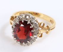 18 carat gold garnet and diamond set ring, with a central garnet and diamond surround, 5.8 grams,