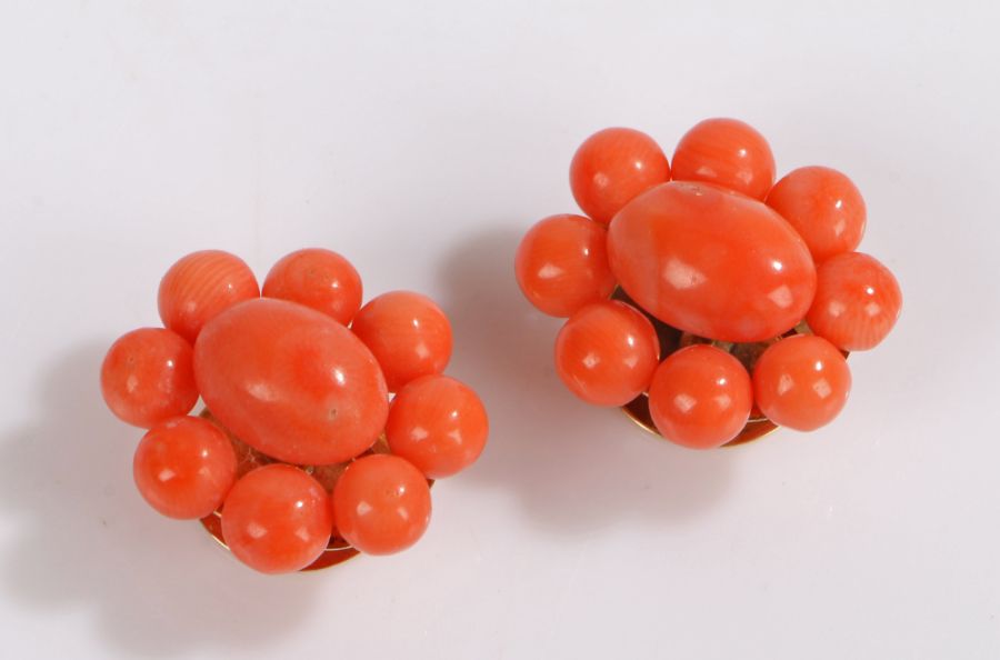 Pair of early 20th Century coral cufflinks, with cabochon cut central piece of coral and a