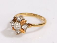 18 carat gold diamond set ring, with five diamonds to the head and four leaf divides, 4.7 grams,