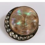 9 carat gold carved opal brooch, in the form of a face as the moon and a crescent to the side,