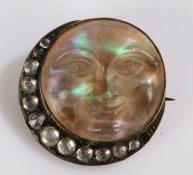 9 carat gold carved opal brooch, in the form of a face as the moon and a crescent to the side,