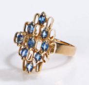 14 carat gold sapphire set ring, the stepped head set with nine sapphires and a series of vacant