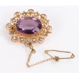 Victorian yellow metal pearl and amethyst brooch, the central amethyst surrounded by pearls in a