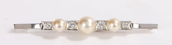 Impressive pearl and diamond set brooch, the central pearl at 8mm in diameter flanked by a further