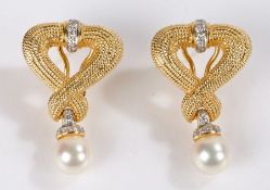 Pair of 18 carat gold pearl and diamond set earrings, with a ring of diamonds above a loop and