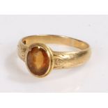 18 carat gold and citrine set ring, the central citrine with engraved scroll work to the