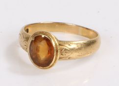 18 carat gold and citrine set ring, the central citrine with engraved scroll work to the