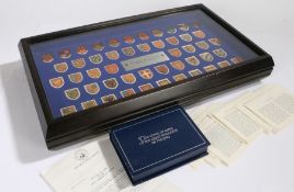 Franklin Mint, A display box containing 50 coats of arms in white and yellow metal of great monarchs