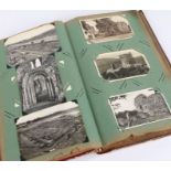 Postcard album containing approximately 150 coloured and black and white postcards, to include