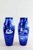 Pair of Doulton blue and white vases, decorated with scenes of children sat by a tree, 28cm high (