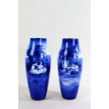 Pair of Doulton blue and white vases, decorated with scenes of children sat by a tree, 28cm high (