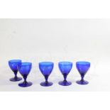 Set of five Bristol blue style rummers, together with eleven clear flared champagne glasses (qty)