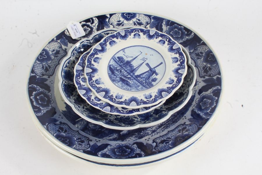 Two Delft blue and white chargers, 39cm diameter, two Delft plates, 19.5cm diameter, all decorated