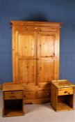 Modern pine double wardrobe, the pair of doors enclosing a hanging rail, fitted two drawers below,