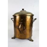 Art Deco spot hammered brass coal bin, having lift up lid, the body with a diamond shaped motif,