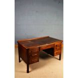 Mid 20th Century oak desk, with three frieze drawers and two drawers to each pedestal, 135cm wide