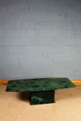 20th century green marble table, the bow sided top raised on a rectangular plinth base, 141cm long