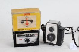 Kodak Instamatic 104 camera, housed in its original packaging, together with a Kodak Brownie