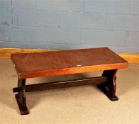 Copper and oak low stretcher table, having oblong copper top raised on shaped supports united by a