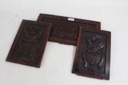 Three Art Nouveau period carved wooden panels, each carved in relief with urns of flowers, 2 x