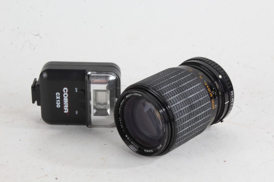 Sigma Zoom-AIII camera lens,  f/3.5-4.5 35-135mm, together with a Cobra CX130 flash (2)