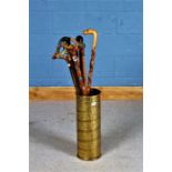 Brass embossed cylindrical stick stand, with contents of nine various walking sticks