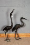 Pair of cast metal garden cranes, the tallest 113cm (2)