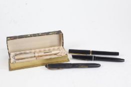 Osmiroid - three black cased fountain pens, to include two '65's, and a pen set comprising a '65'