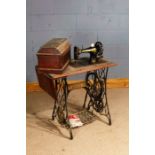 Singer treadle sewing machine, raised on cast iron base, with drop leaf, 78cm wide excluding leaf