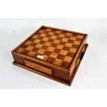Wooden draughts/chess board. a single drawer enclosing draughts pieces, 36cm