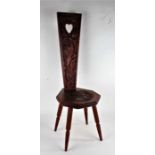 20th century Welsh carved oak love chair/stool, the tapering back rest having pierced heart motif,