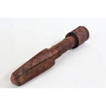 Eastern carved wooden symbolic dagger, having four faces to the handle, with a chipped and geometric